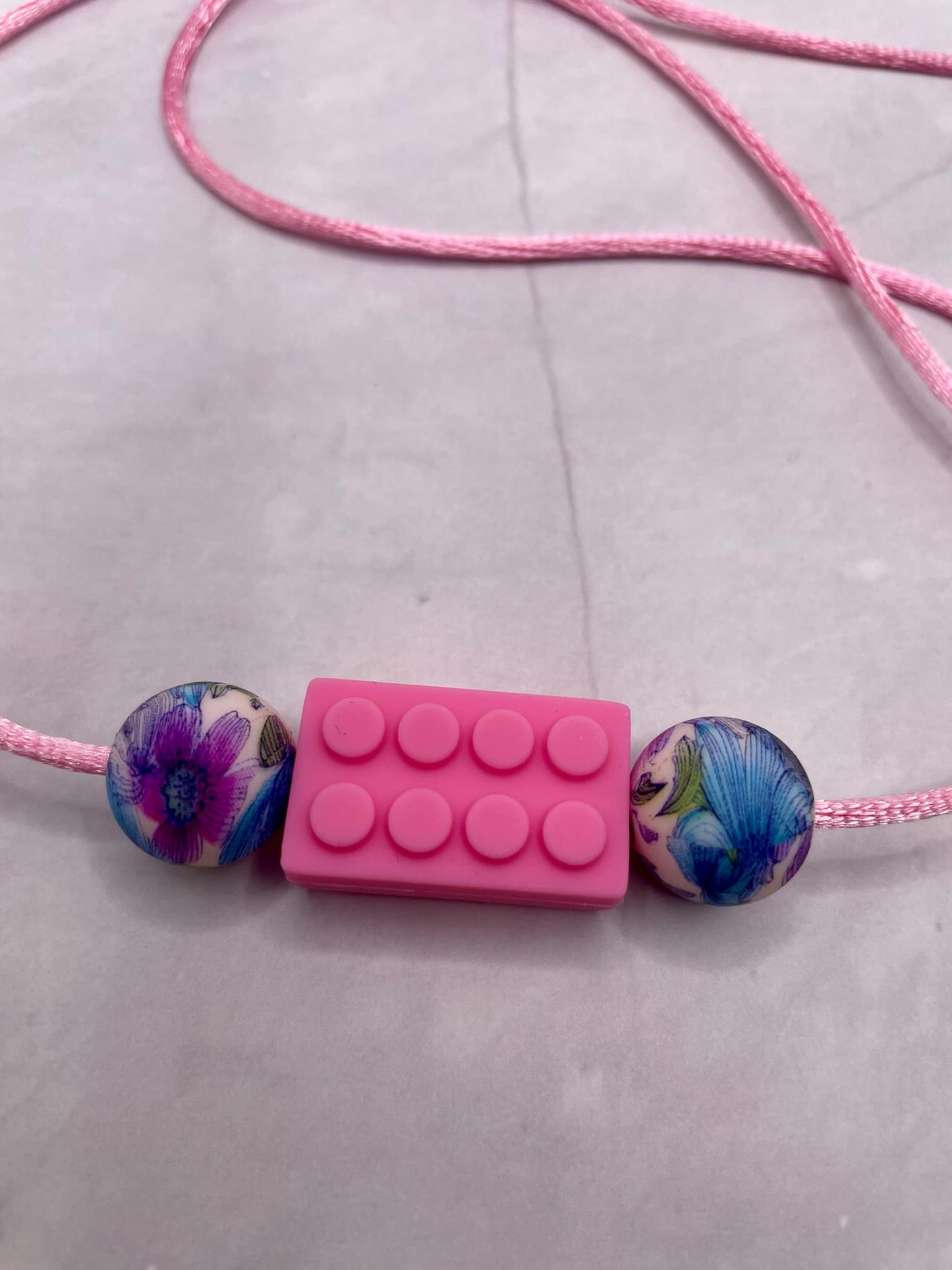 Jouet de dentition puzzle; PENDENTIF - EN FORME DE LEGO FLEURAL FDMT ORAL MOTEUR